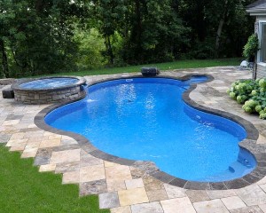 Inground pool surrounded with patio stones