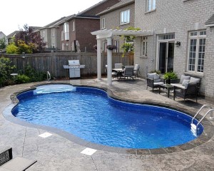 Inground pool with dark blue liner