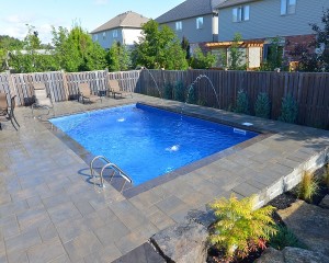 Square shaped inground pool with patio area